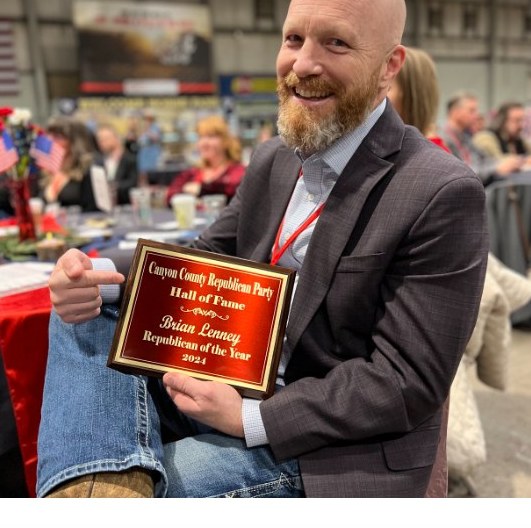 Brian Lenney holding his Canyon County Republican Party Hall of Fame plaque